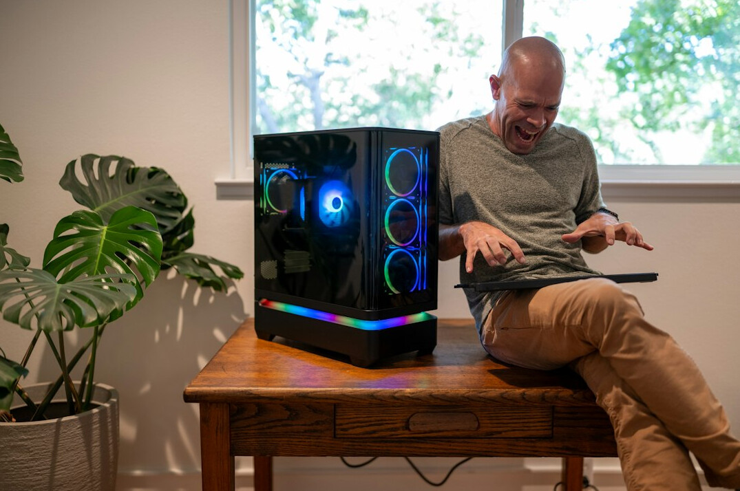 Man video editor with headphones working at an editing station with two monitors