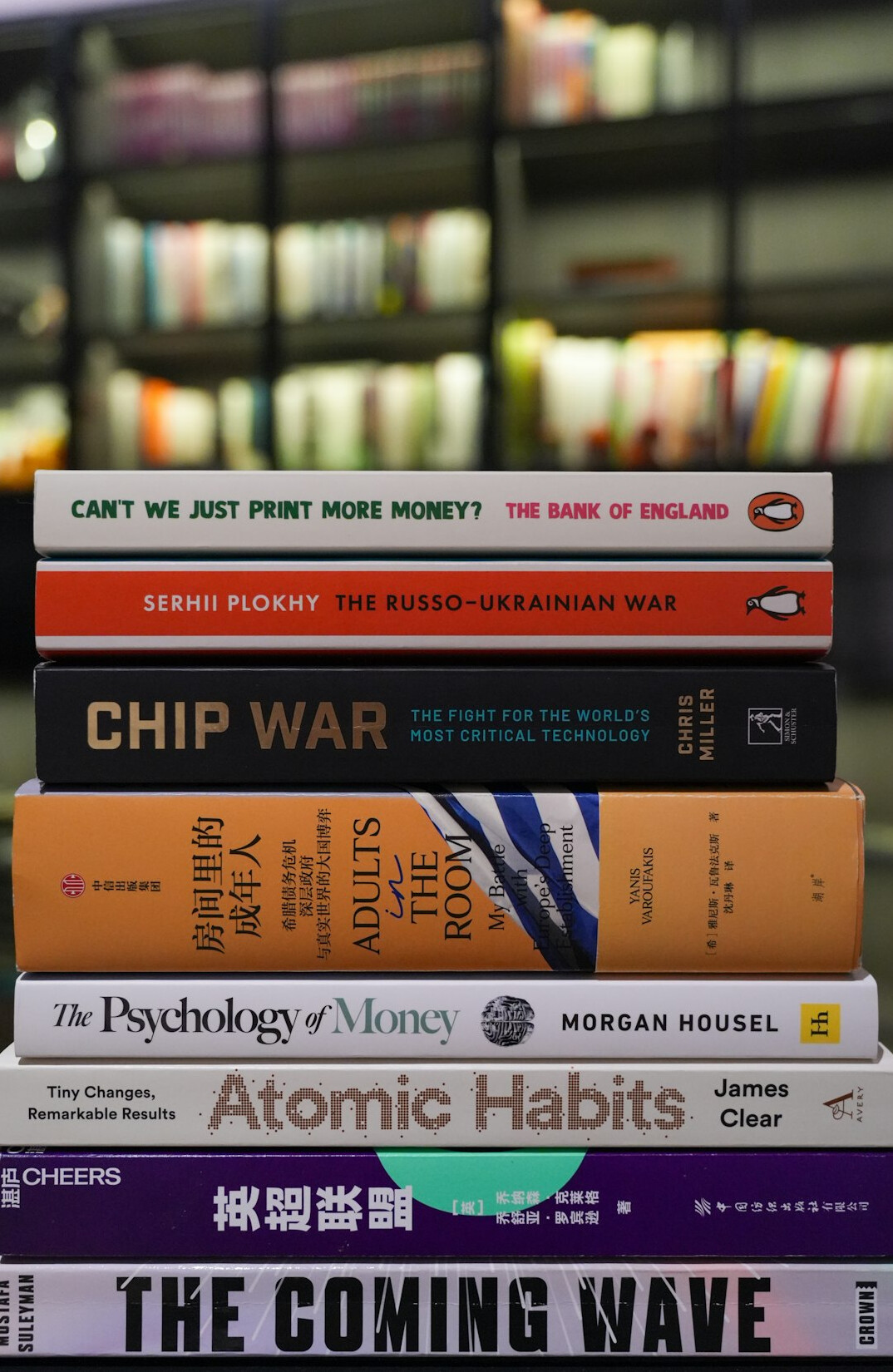 Stack of books about graphic design and advertising history on a shelf