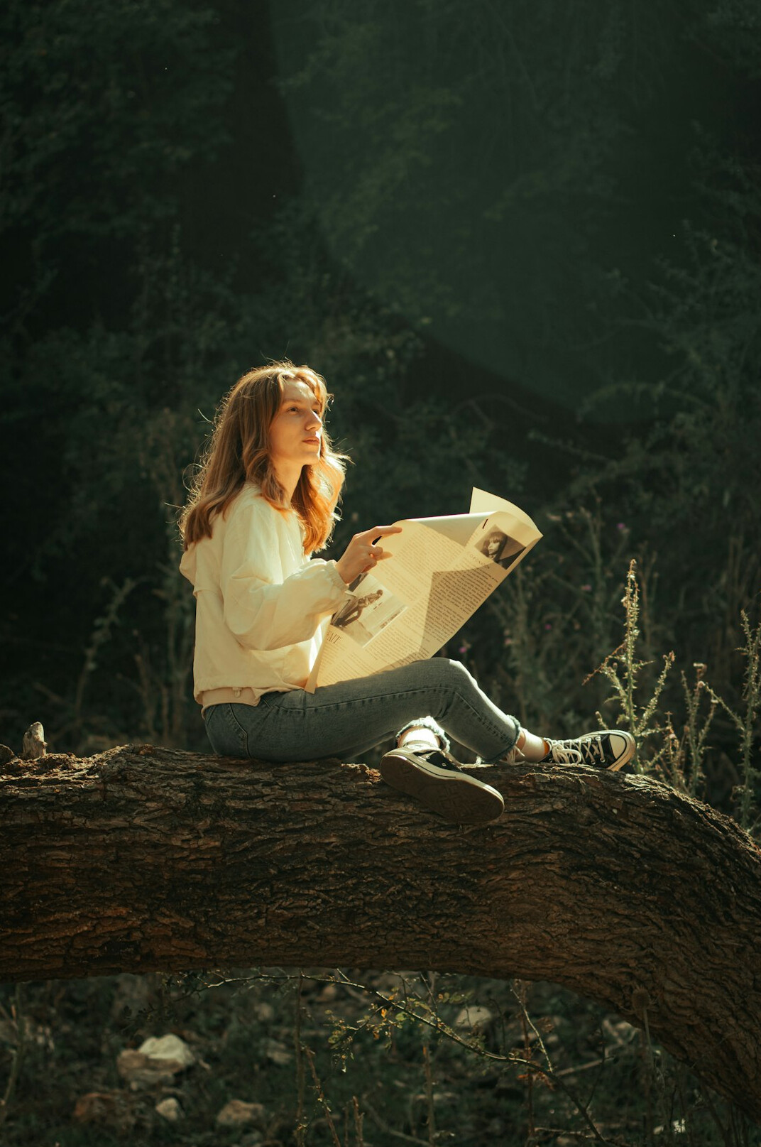 Woman copywriter reading printed pages at a desk in a bright office